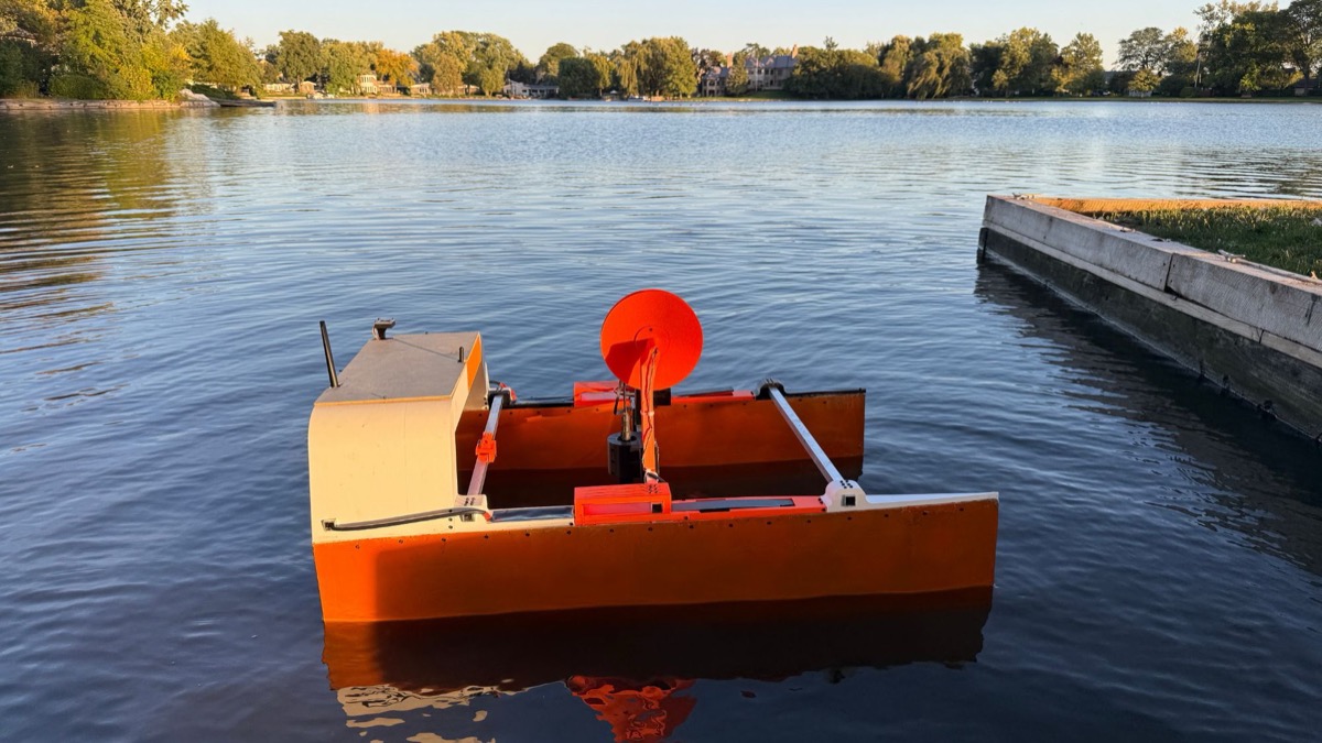 The finished EcoFloat V3 floating on a calm lake in evening sun next to a wooden dock, matching the CAD model.